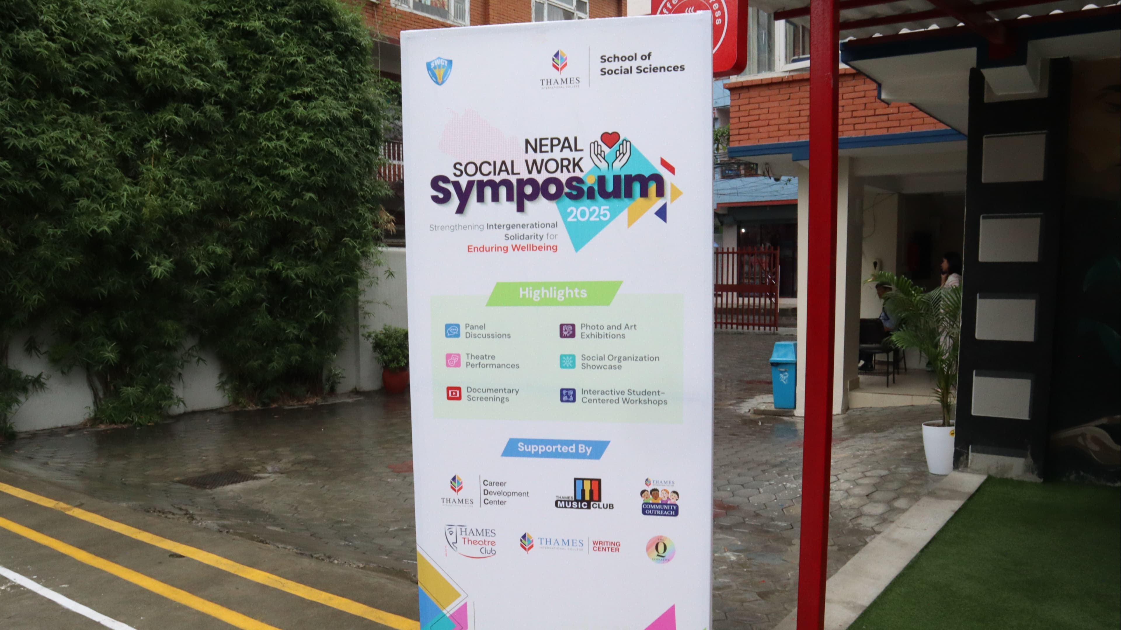 A banner advertises the "Nepal Social Work Symposium 2025" from Thames International College's School of Social Sciences, detailing its program and supporters.