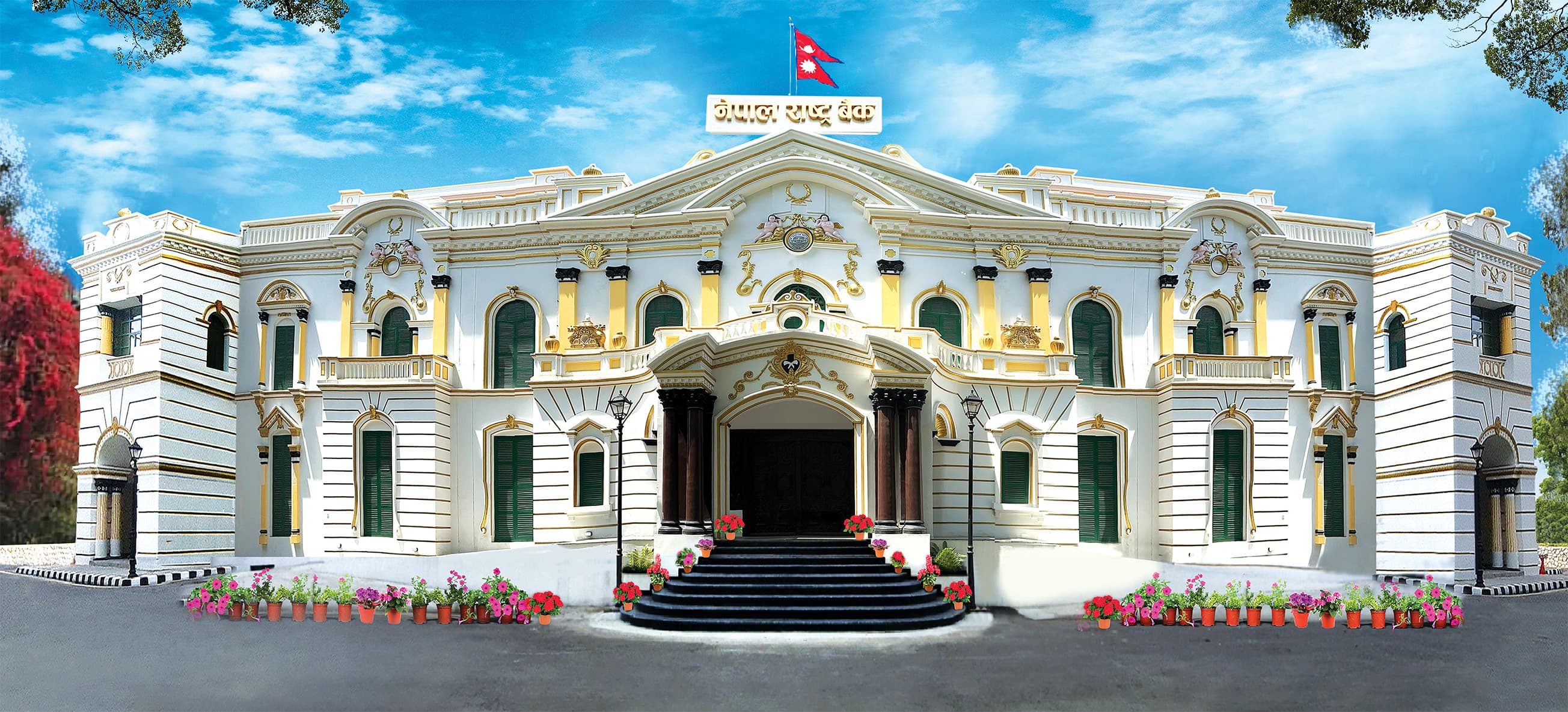 A picture of white and yellow building with green windows and has a Nepal's flag at the top which represent Nepal Rastra Bank